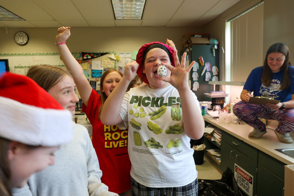 students celebrate their egg not cracking during a science experiment