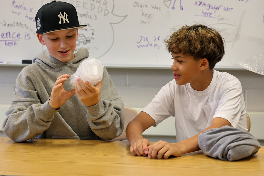 students work on egg holder