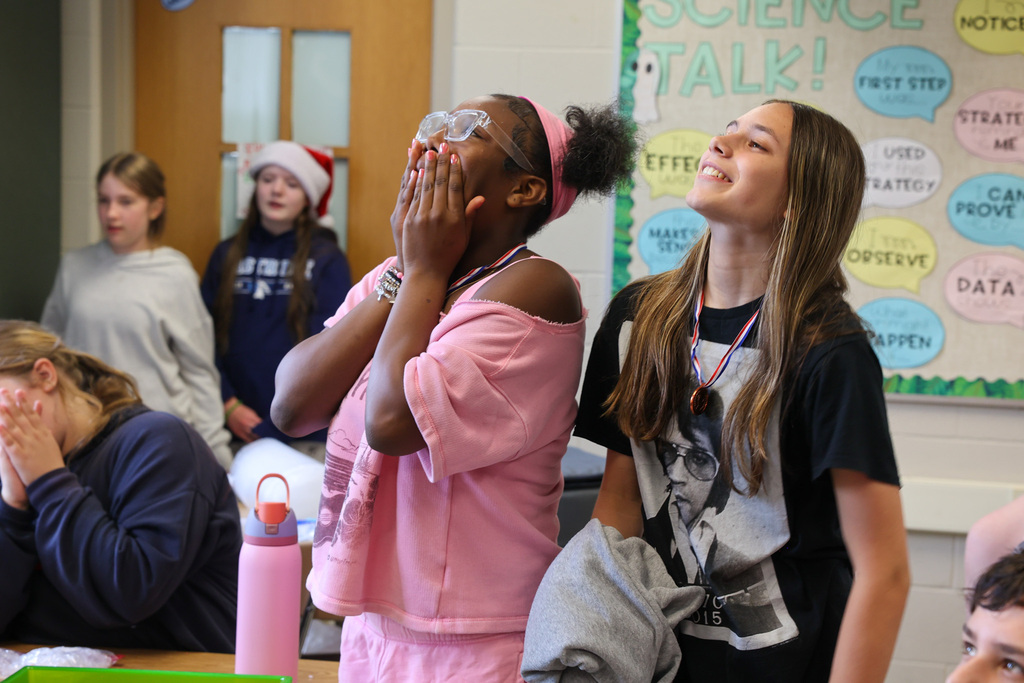 student watch as their eggs are dropped on the ground