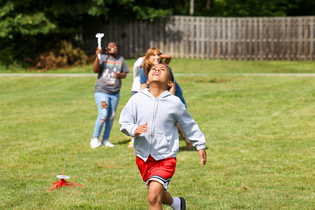 student runs after rocket