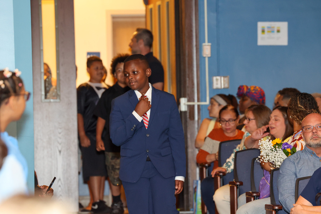 student walks into aisle with suit 