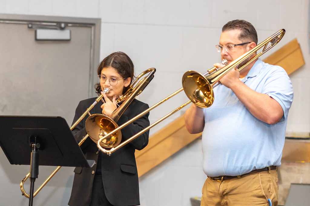 Tyler and Mr. Savine playing trombones