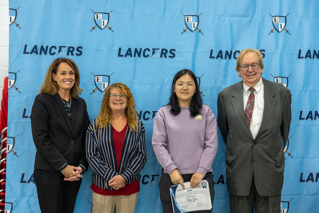 Newly tenured staff with board president and vice president and the superintendent