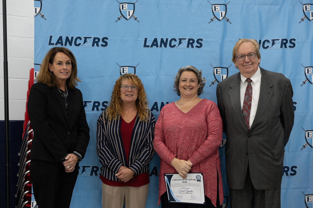 Newly tenured staff with board president and vice president and the superintendent