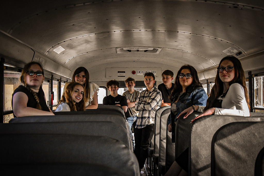 8th grade class on a school bus