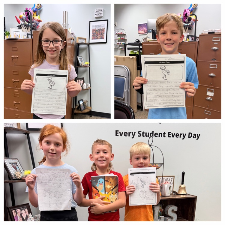 students holding their writing 