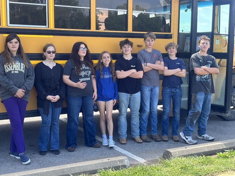 students in front of bus