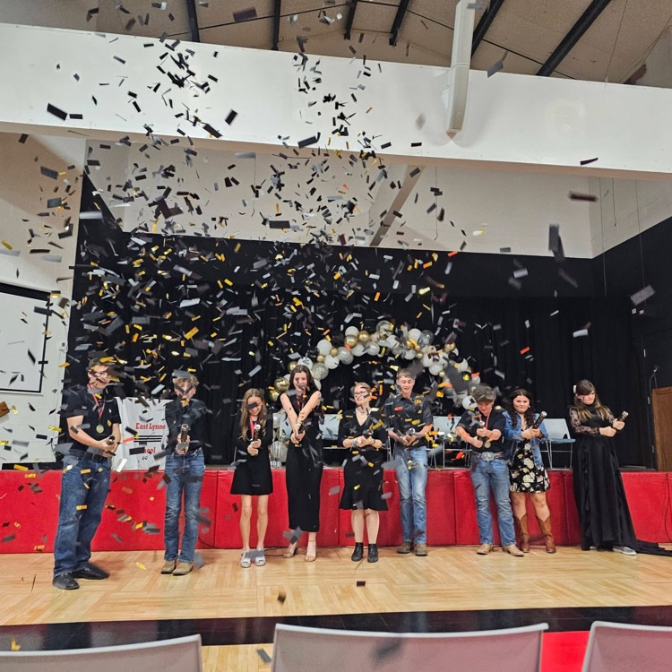 students shooting off confetti
