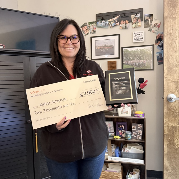 teacher holding check