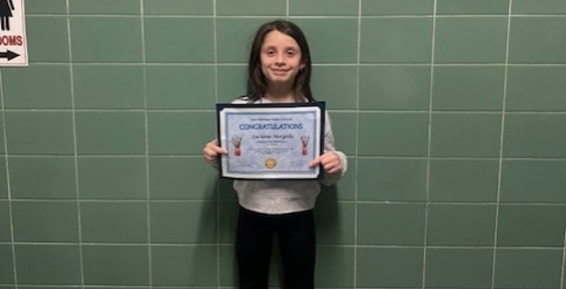 Student holding certificate.