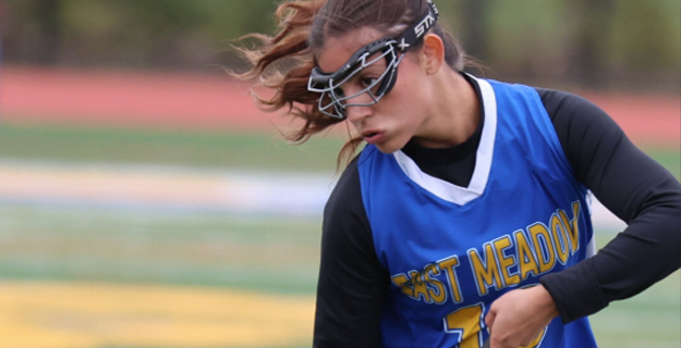 Student playing field hockey