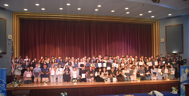 Student group photo on stage.
