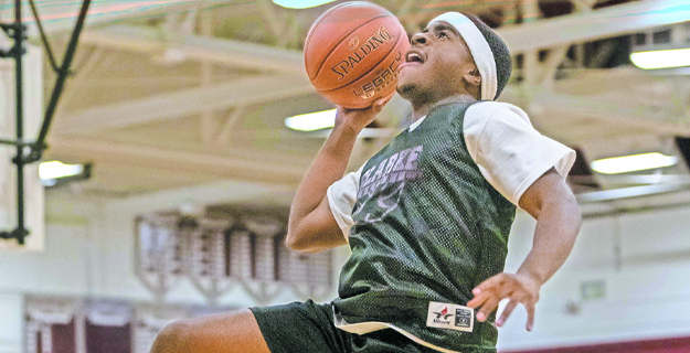 Student playing basketball.