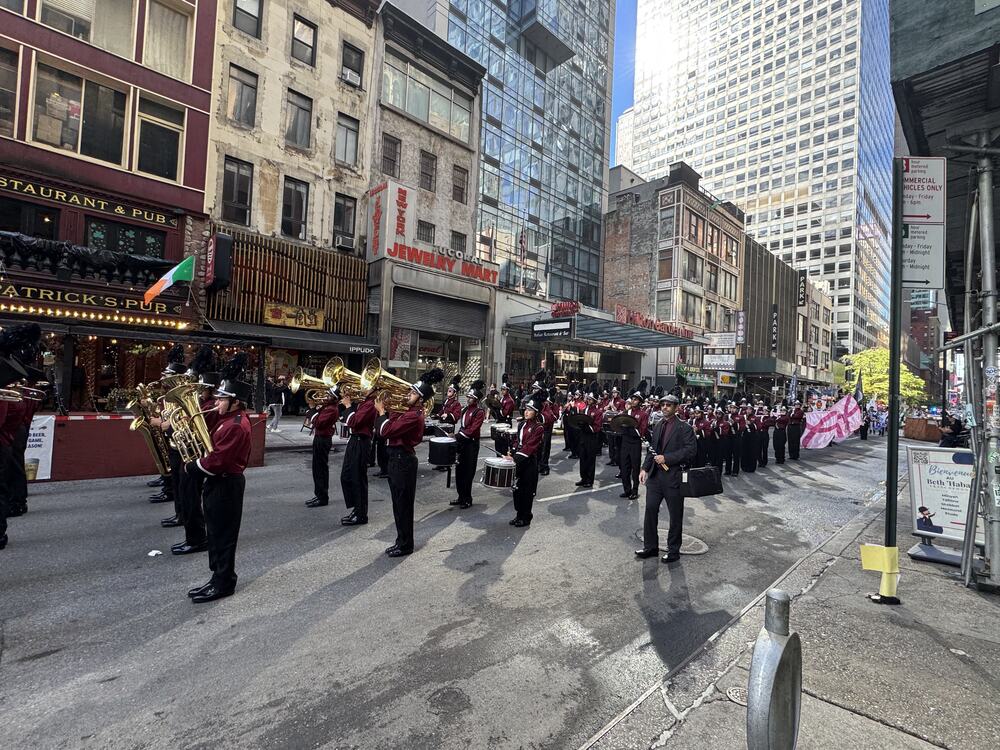 Student ban marching through city street.