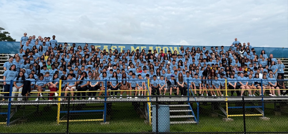 people in light blue shirts in bleachers