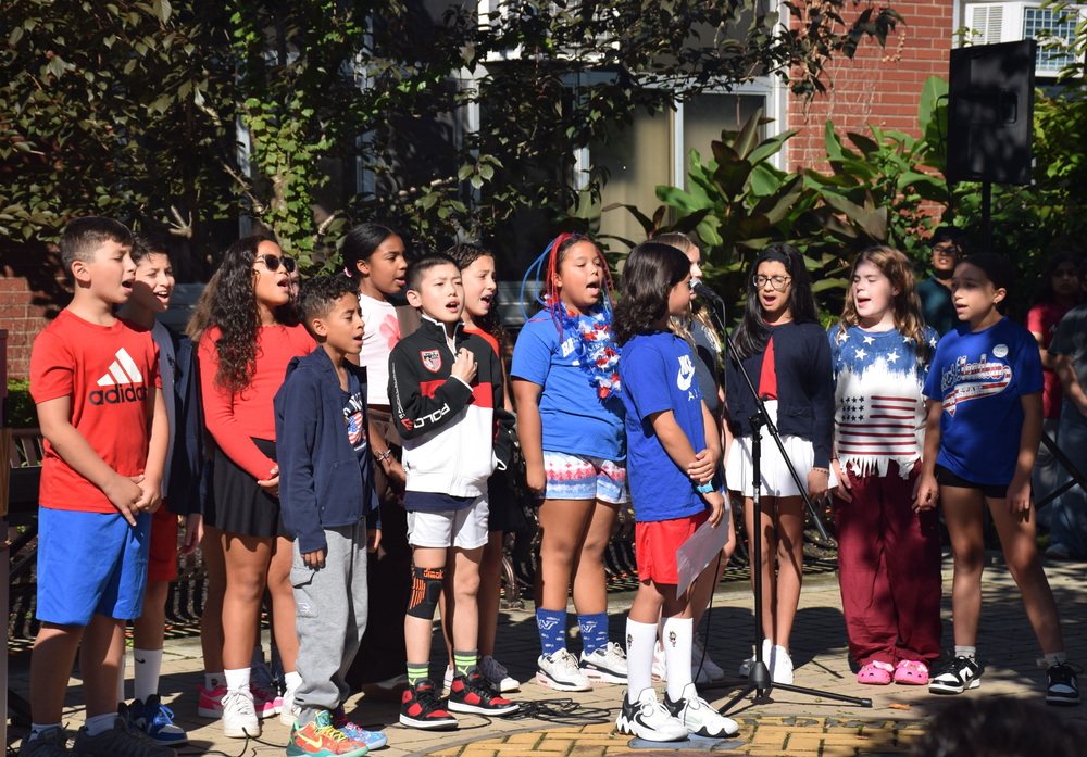 students outdoors on pavement in a figure 8 shape