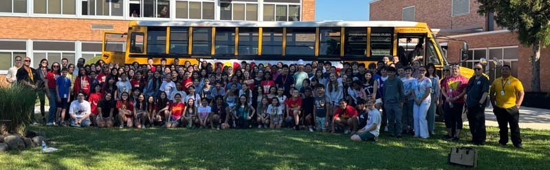 Students outside by school bus.
