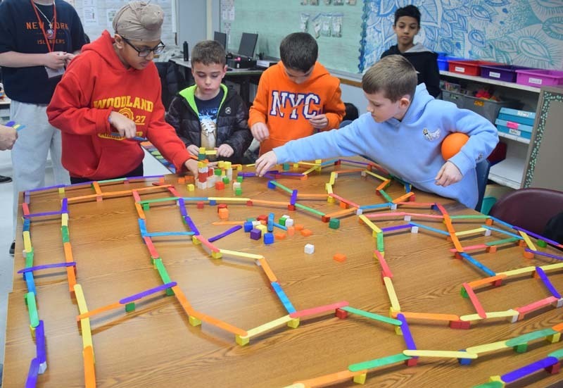 Students working on elaborate project together.