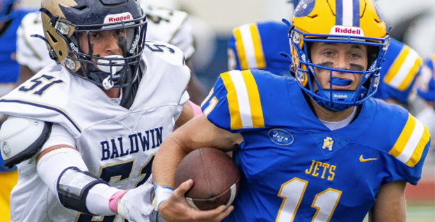 East Meadow quarterback Trevor Smith, right, had two passing touchdowns and one on the ground in Saturday's 35-16 win at Baldwin.