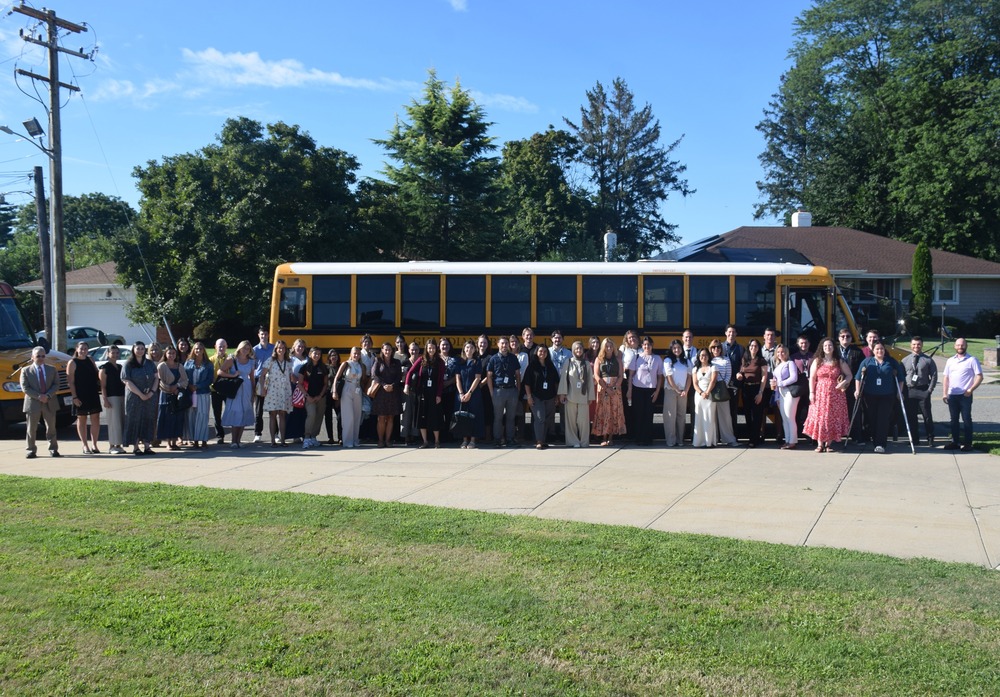 New teachers outside by school bus.