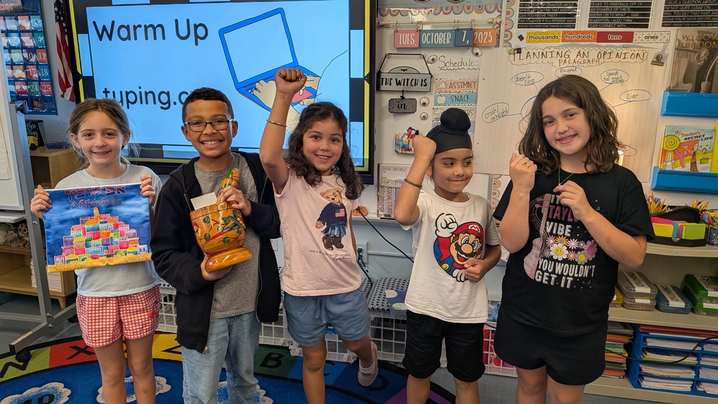 students holding artifacts from their culture