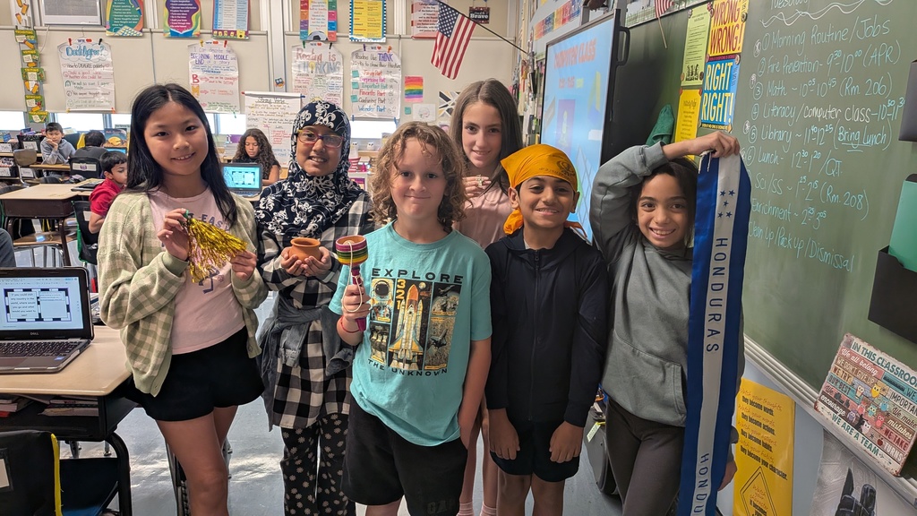 students holding artifacts from their culture