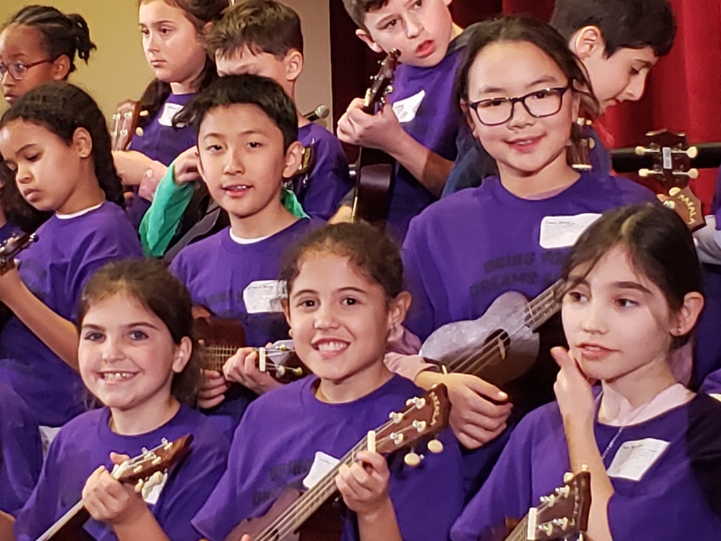 Students performing music on the ukulele at PEAK!