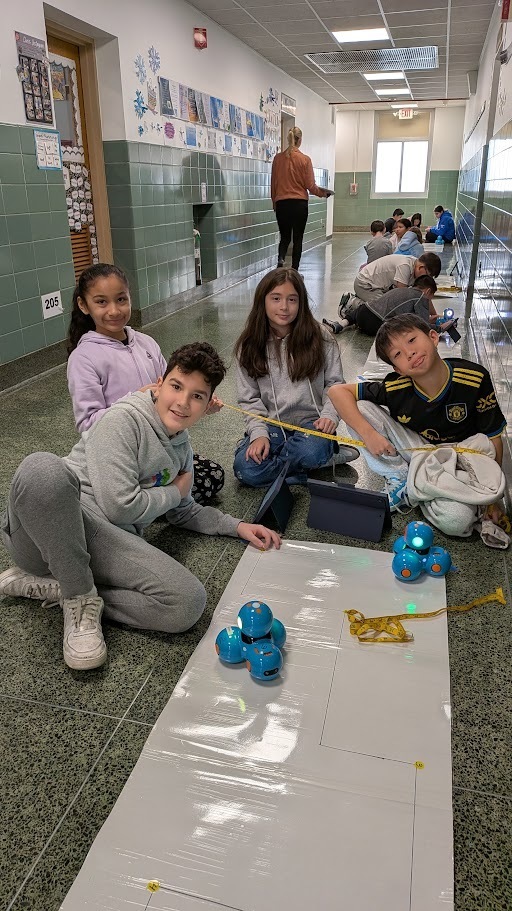 fifth graders working with dash robots