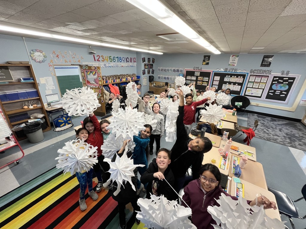 fourth graders making snowflakes