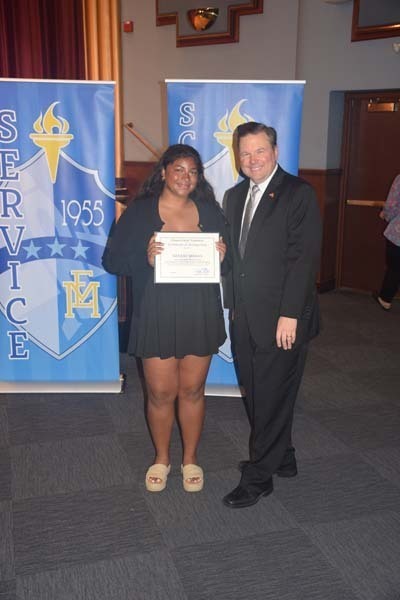 Photo of students holding certificates and plaques at East Meadow High School’s awards ceremony.