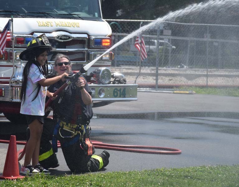 Student receiving demonstration from fireman.