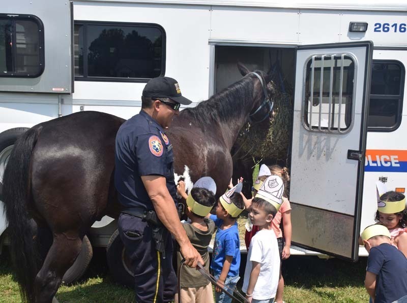 Student receiving demonstration from fireman.