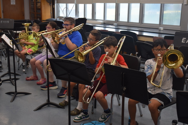 orchestra practice with conductor and students