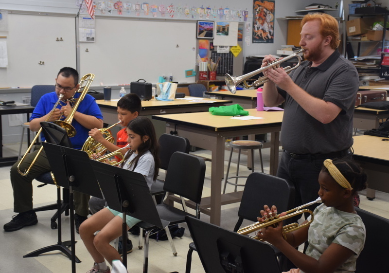 orchestra practice with conductor and students