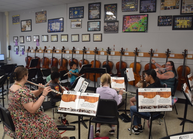 orchestra practice with conductor and students