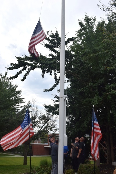 People observing flag raising ceremony