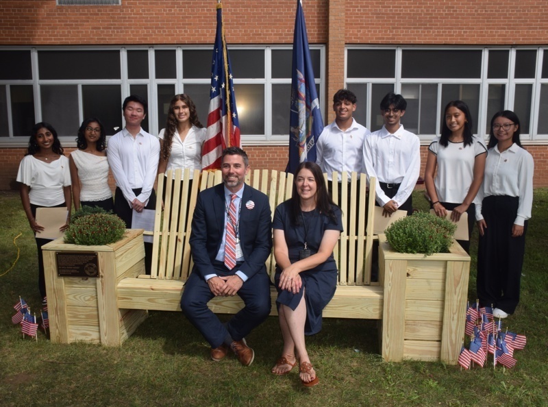 Group of people with flags and bench
