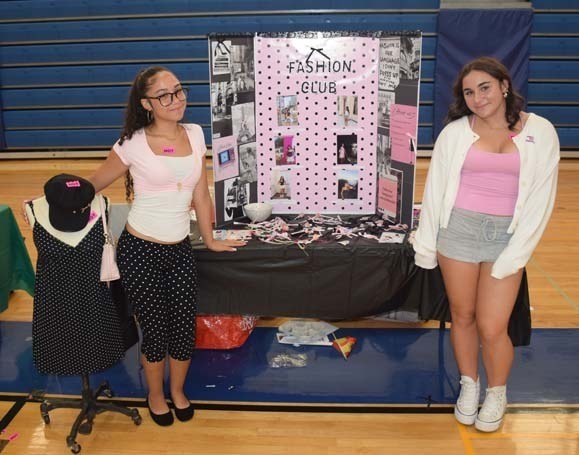 Photo of high school students with posterboard of their club.