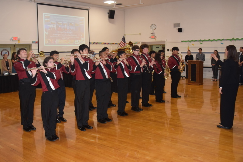 Group playing instruments in a gymnasium