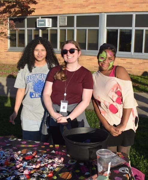 Students smiling together outside.