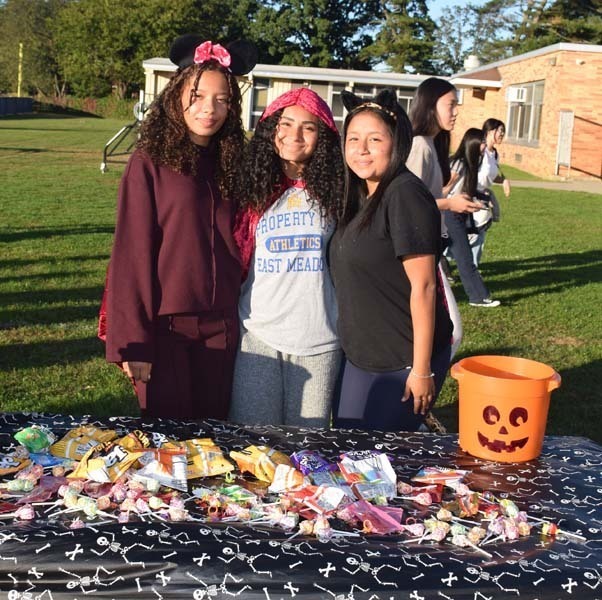 Students smiling together outside.