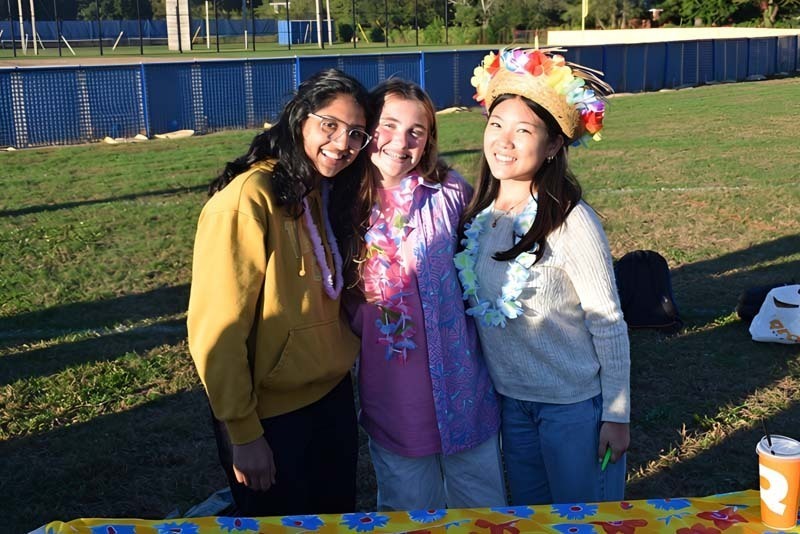 Students smiling together outside.