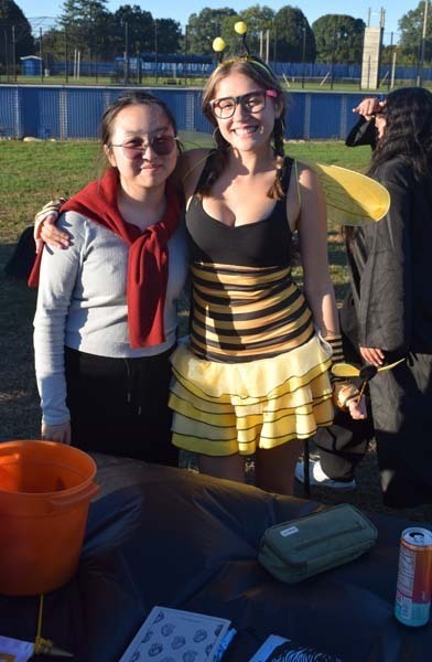 Students smiling together outside.