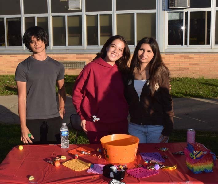 Students smiling together outside.