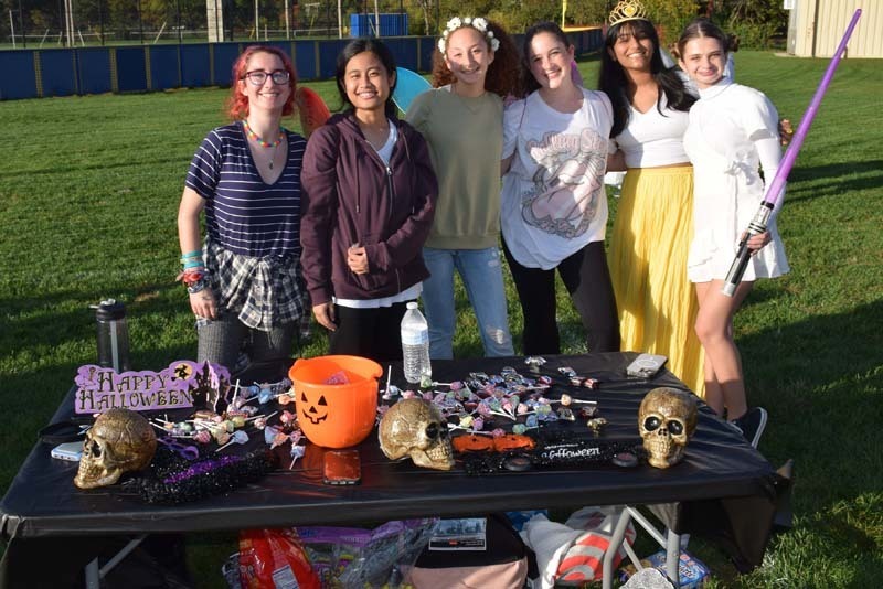 Students at a table during trick or treaters event