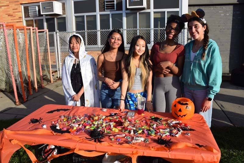 Students at a table full of candy