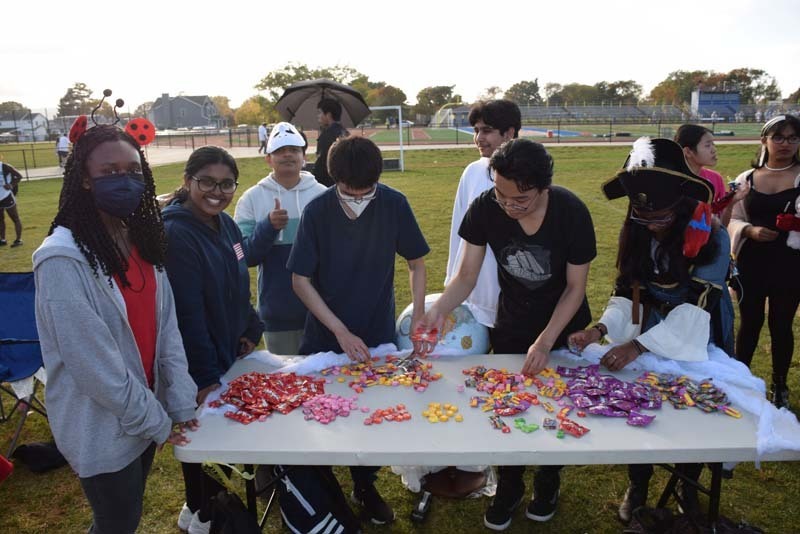 Students at a table full of candy