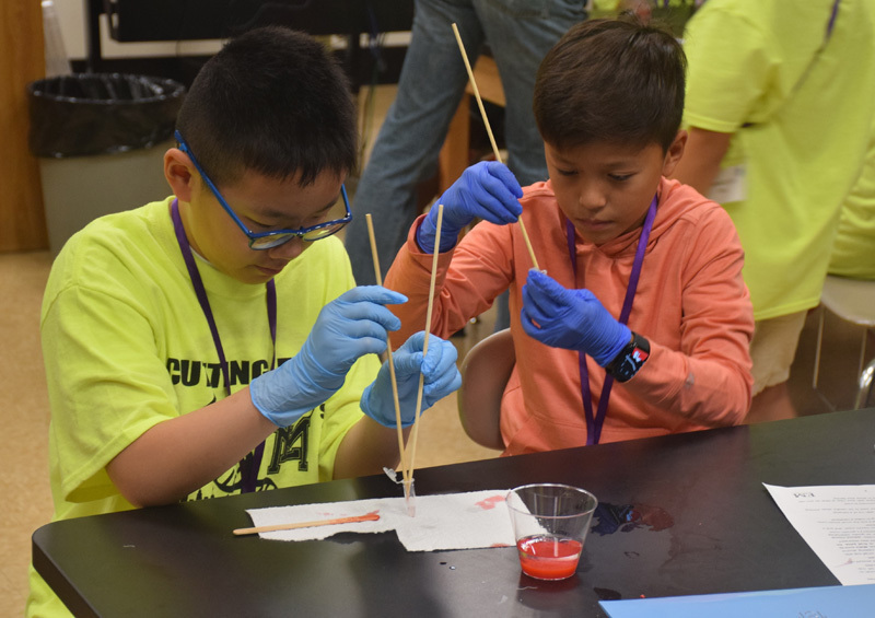 students in classroom in yellow shirts
