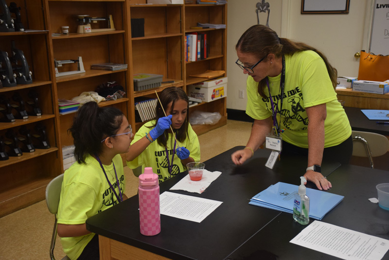 students in classroom in yellow shirts