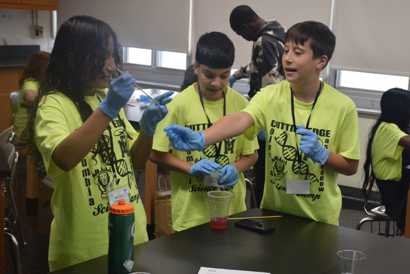 students in classroom in yellow shirts